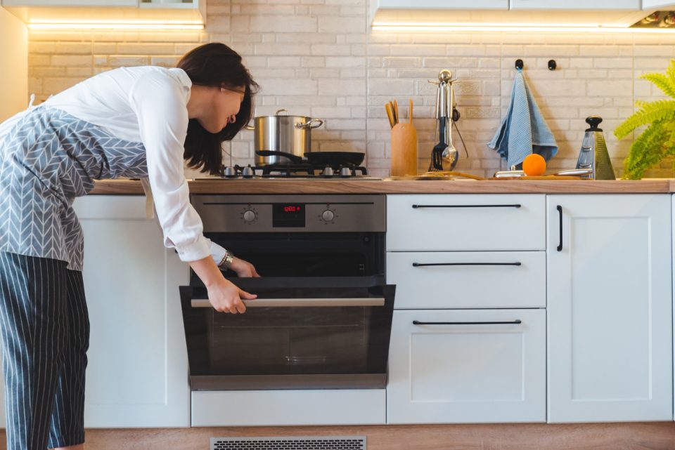 Woman baking a dessert in the oven