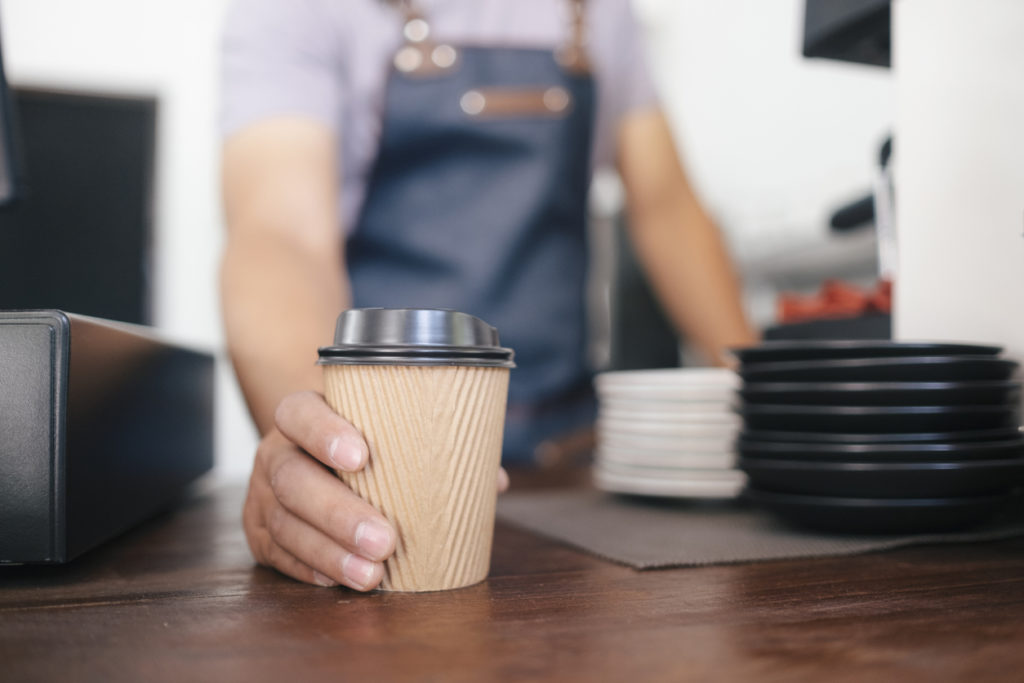 Man serving to-go coffee