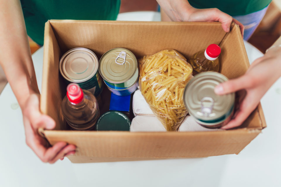 Volunteer with box of food.