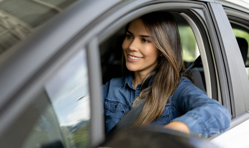 happy woman driving her ca