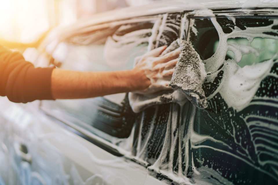 man soaping his car.