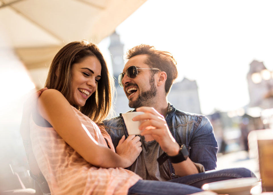 cheerful couple enjoying outdoor dining