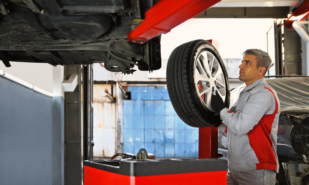 Car Tire - Vehicle Part Removing and Installing in the Auto Repair Shop