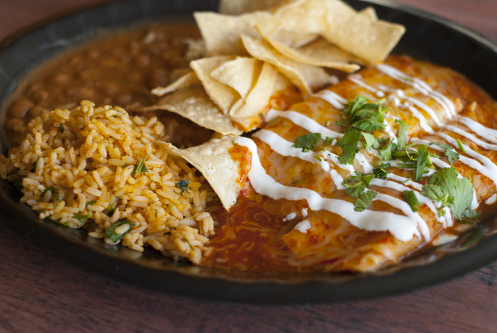 Delicious plateful of Enchiladas smothered in sauce and cheese.