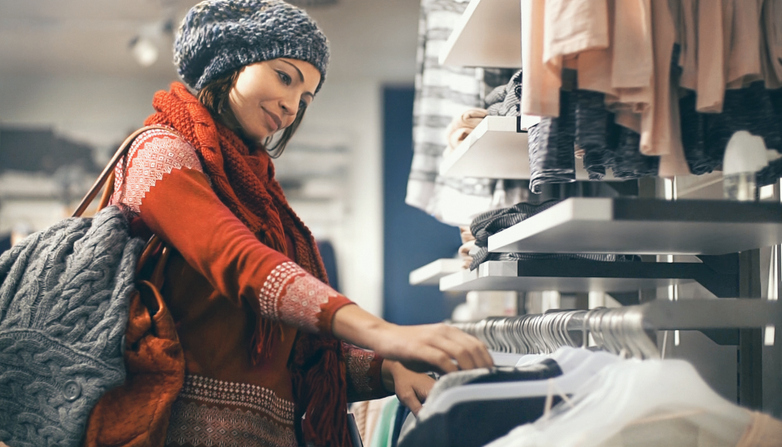 Woman buying clothes at department store.