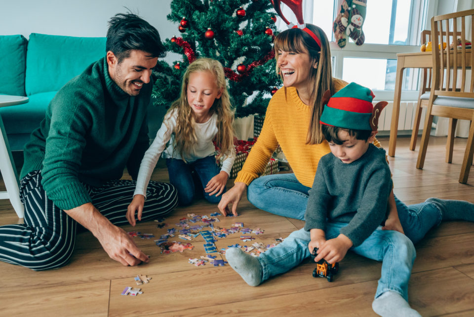 Family completing a puzzle together after Christmas