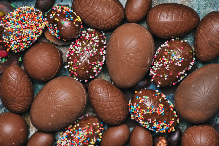 Chocolate Easter eggs with dessert sprinkles on a table top view background pattern flat lay